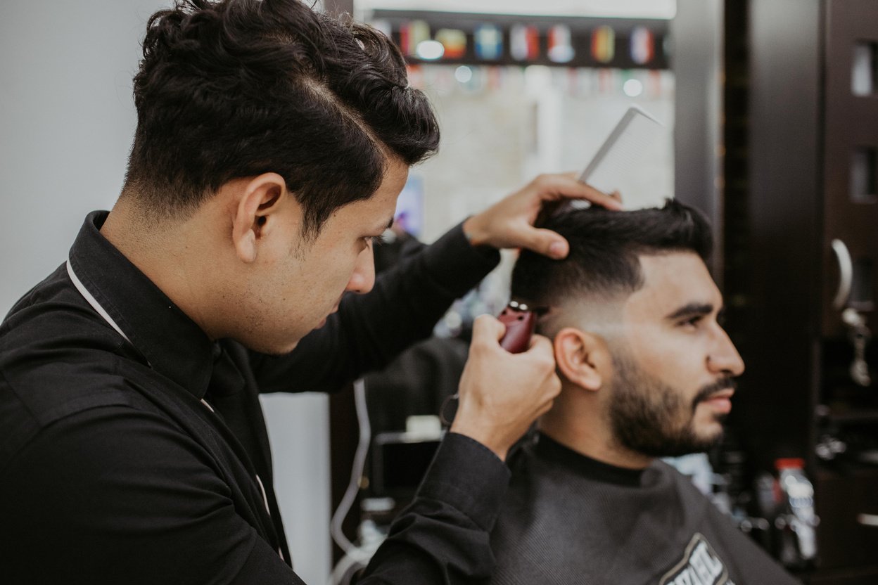 Man Trimming Another Man's Hair